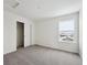 Well-lit bedroom featuring neutral carpeting and a large closet at 692 Apex Rise St, Erie, CO 80516