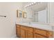 Well-lit bathroom features vanity, mirror, shower with modern fixtures in a condo at 3205 S Walden Ct # B, Aurora, CO 80013