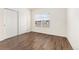 Minimalist bedroom with hardwood floors, sliding closet doors, and natural light at 3205 S Walden Ct # B, Aurora, CO 80013