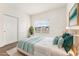 Bright staged bedroom with modern decor, sliding closet doors, and view of the exterior at 3205 S Walden Ct # B, Aurora, CO 80013