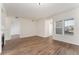 Spacious living room with hardwood floors, large windows, and access to the adjacent rooms at 3205 S Walden Ct # B, Aurora, CO 80013