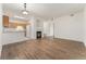 Open-concept living room features a cozy fireplace and adjacent kitchen with stainless appliances at 3205 S Walden Ct # B, Aurora, CO 80013