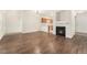 Bright living room featuring hardwood floors, a fireplace, and an open layout to the kitchen at 3205 S Walden Ct # B, Aurora, CO 80013