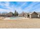Community pool with a clubhouse and open space on a sunny day at 3205 S Walden Ct # B, Aurora, CO 80013
