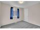 Bedroom featuring neutral walls, a gray carpet, and a window with blue drapes at 270 N Holcomb Cir, Castle Rock, CO 80104