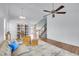 Spacious living room with open staircase, featuring hardwood floors, ceiling fan, and lots of natural light at 270 N Holcomb Cir, Castle Rock, CO 80104