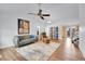 Open-concept living room featuring wood floors, a ceiling fan, and a comfortable seating arrangement at 270 N Holcomb Cir, Castle Rock, CO 80104