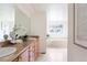 Bright bathroom with double sinks, quartz countertops, and a garden tub at 538 Cook St, Denver, CO 80206