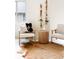 Comfortable bedroom sitting area with two chairs, hide rug, and accent table by a window at 538 Cook St, Denver, CO 80206