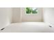 A bright bedroom featuring a large window letting in natural light, neutral paint and soft carpet at 538 Cook St, Denver, CO 80206
