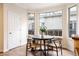 Bright breakfast nook with hardwood floors features a table and chairs by large windows at 538 Cook St, Denver, CO 80206