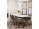 Bright dining room features a modern chandelier, wood shutters, and an elegant dining table at 538 Cook St, Denver, CO 80206
