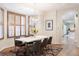 Bright dining room features a modern chandelier, wood shutters, and an elegant dining table at 538 Cook St, Denver, CO 80206