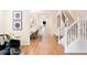 Bright entryway featuring hardwood floors, a staircase, and a view into the dining room at 538 Cook St, Denver, CO 80206