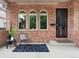 Cozy front porch with brick facade, seating, and stylish decor by the front door at 538 Cook St, Denver, CO 80206