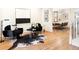 Stylish living room with hardwood floors, black accent chairs, and an open view to the dining area at 538 Cook St, Denver, CO 80206