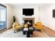 Comfortable living room with a cozy fireplace, a modern black table, and two stylish yellow chairs at 538 Cook St, Denver, CO 80206