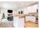 Open-concept living space flows from the kitchen with a breakfast bar to a cozy living area at 538 Cook St, Denver, CO 80206