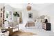 Bright main bedroom with a woven chandelier, art, and a sitting area with a neutral color palette at 538 Cook St, Denver, CO 80206