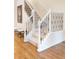 Bright staircase features white banisters with decorative black iron spindles and carpeted treads at 538 Cook St, Denver, CO 80206