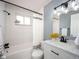 Bright bathroom featuring white tiled walls, updated fixtures, and a modern vanity at 155 S Pennsylvania St # 310, Denver, CO 80209