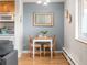 Quaint dining area with seating for two, enhanced by natural light from the adjacent window at 155 S Pennsylvania St # 310, Denver, CO 80209