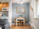 Cozy dining area featuring a table for two adjacent to the kitchen and a window with natural light at 155 S Pennsylvania St # 310, Denver, CO 80209