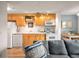 Bright kitchen featuring light wood cabinetry, modern appliances, and an adjacent dining area at 155 S Pennsylvania St # 310, Denver, CO 80209