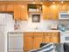 Cozy kitchen featuring light wood cabinetry, white countertops, and modern appliances at 155 S Pennsylvania St # 310, Denver, CO 80209