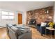 Warm living room showcasing a brick fireplace and an inviting seating area at 155 S Pennsylvania St # 310, Denver, CO 80209