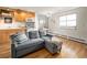 Comfortable living room featuring a sofa and hardwood floors adjacent to the kitchen and dining area at 155 S Pennsylvania St # 310, Denver, CO 80209