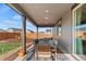 Inviting covered back patio featuring an outdoor table and chairs, ideal for entertaining at 21 N Edge Cliff St, Castle Rock, CO 80104