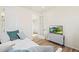 Comfortable bedroom featuring a daybed, a tv on a small table, and a door leading to the hallway at 21 N Edge Cliff St, Castle Rock, CO 80104