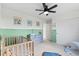 bedroom with a ceiling fan, green wainscoting, and changing table at 21 N Edge Cliff St, Castle Rock, CO 80104