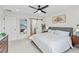 Bright bedroom features a ceiling fan, sliding barn door to the ensuite, and neutral decor at 21 N Edge Cliff St, Castle Rock, CO 80104