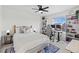 Bright bedroom features a ceiling fan, desk, bookshelf, and large window views at 21 N Edge Cliff St, Castle Rock, CO 80104