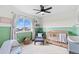 bedroom with green wainscoting, blue accent chair, and large window views at 21 N Edge Cliff St, Castle Rock, CO 80104