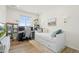 Bright bedroom featuring a comfortable daybed, desk, and shelving for storage and decor at 21 N Edge Cliff St, Castle Rock, CO 80104