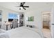 Bright bedroom features a ceiling fan, desk, bookshelf, and large window views at 21 N Edge Cliff St, Castle Rock, CO 80104