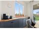 Charming coffee station with wooden countertop, gray cabinetry, and plants overlooking the backyard at 21 N Edge Cliff St, Castle Rock, CO 80104