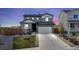 Charming two-story home features a manicured front yard, a two-car garage, and solar panels on the roof at 21 N Edge Cliff St, Castle Rock, CO 80104