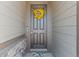 A welcoming front door is adorned with a yellow floral wreath and accented by stone details at 21 N Edge Cliff St, Castle Rock, CO 80104
