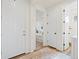 Hallway featuring an open bedroom and bathroom with white doors and neutral decor throughout at 21 N Edge Cliff St, Castle Rock, CO 80104