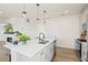 Open kitchen features a center island with barstool seating and stainless steel appliances at 21 N Edge Cliff St, Castle Rock, CO 80104