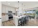 Modern, open-concept kitchen with stainless steel appliances, a large island, and adjacent dining area at 21 N Edge Cliff St, Castle Rock, CO 80104
