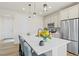 Bright eat-in kitchen boasts a large center island with seating, stainless steel appliances, and pendant lighting at 21 N Edge Cliff St, Castle Rock, CO 80104