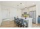 Bright eat-in kitchen boasts a large center island with seating, stainless steel appliances, and pendant lighting at 21 N Edge Cliff St, Castle Rock, CO 80104