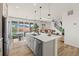 Open kitchen features a center island with barstool seating and stainless steel appliances that flows to the living room at 21 N Edge Cliff St, Castle Rock, CO 80104