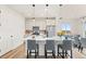Bright eat-in kitchen boasts a large center island with seating, stainless steel appliances, and pendant lighting at 21 N Edge Cliff St, Castle Rock, CO 80104
