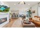 Open-concept living room showcasing kitchen, dining, fireplace, and a TV above the fireplace at 21 N Edge Cliff St, Castle Rock, CO 80104